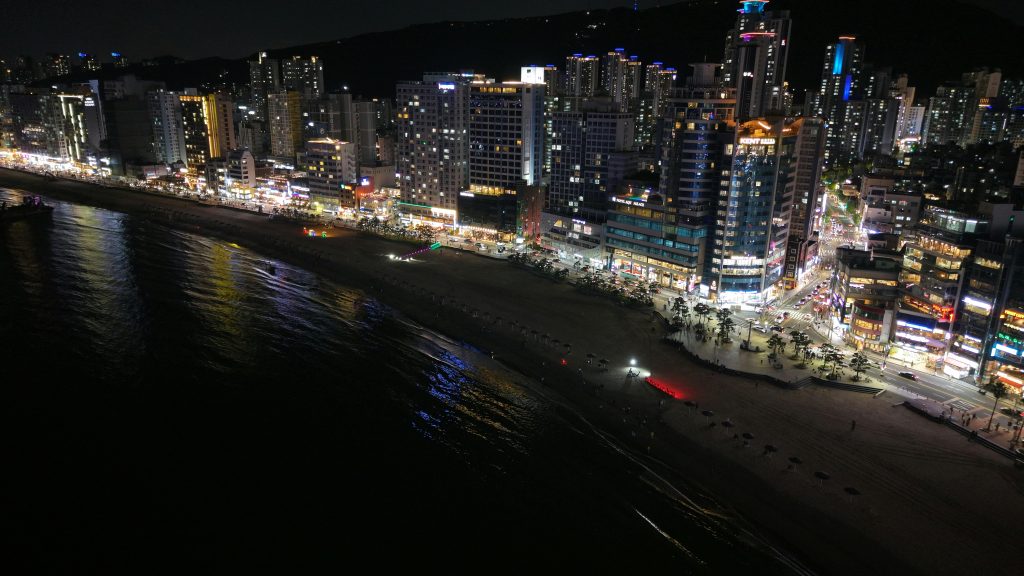 Stunning night view of Busan's illuminated cityscape along the coastline.